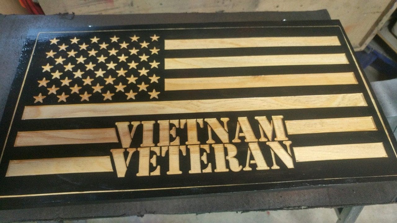 Wooden Vietnam Veteran plaque with American flag.